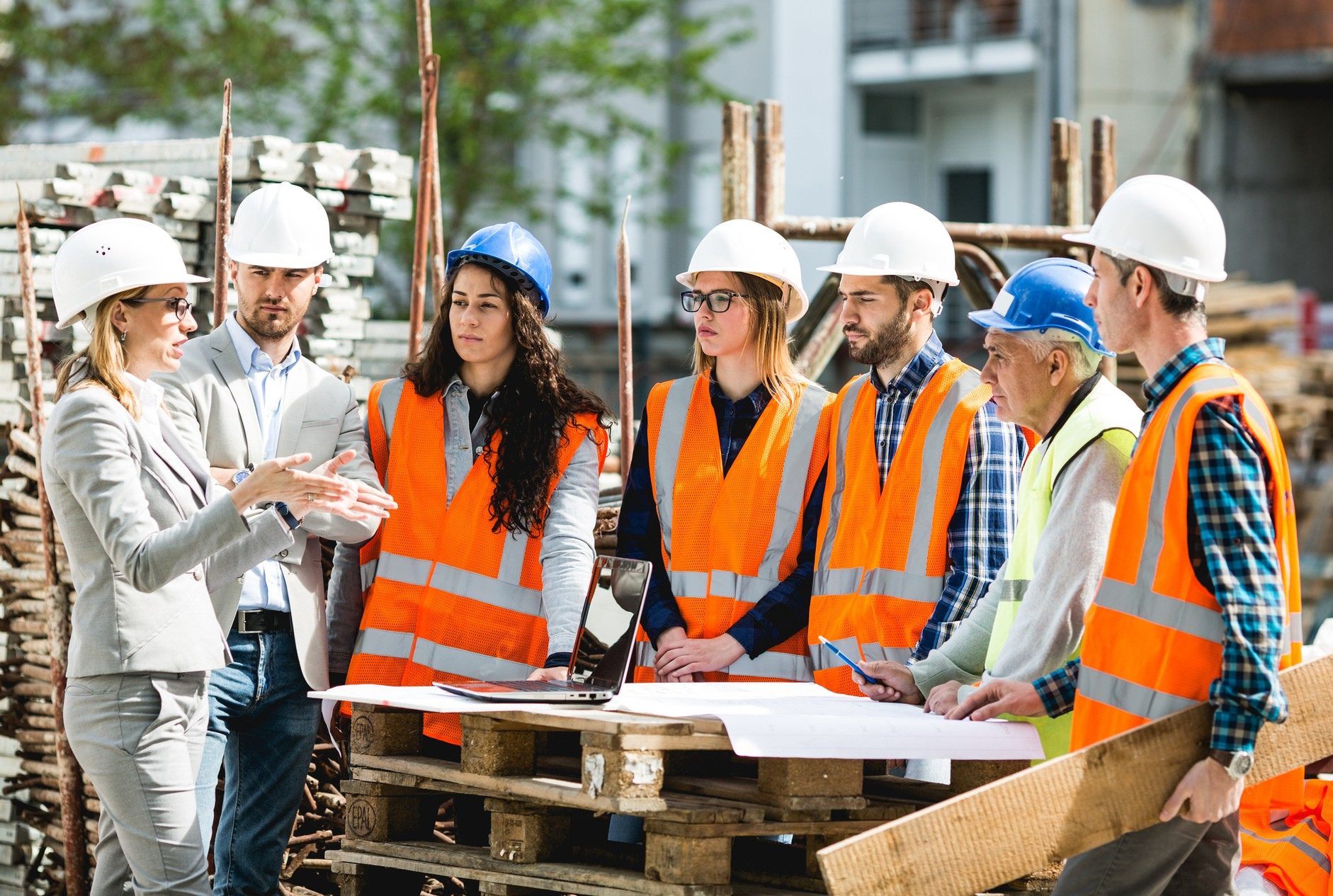 Construction team discussing plans on site.