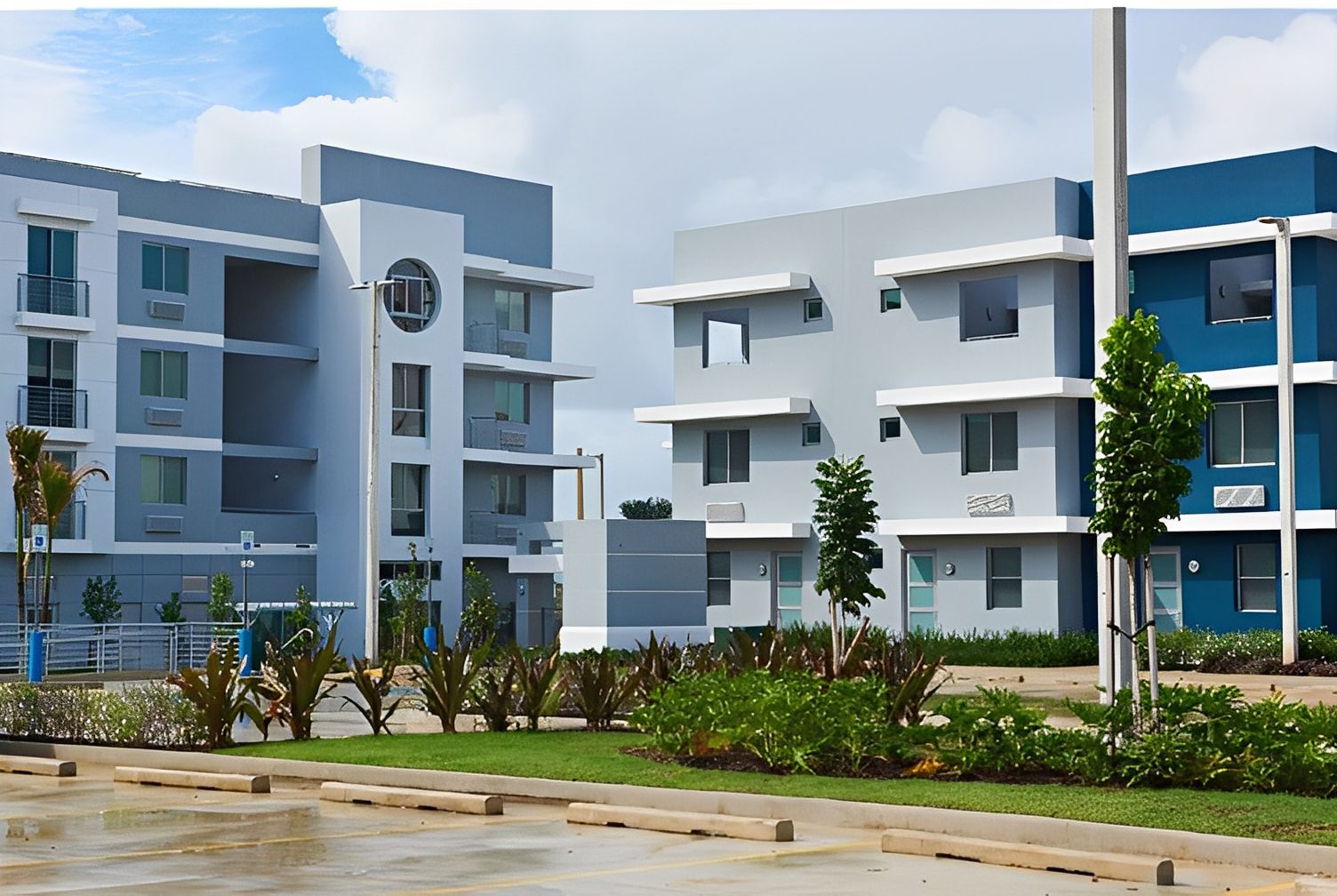 Modern apartment buildings with green landscaping.