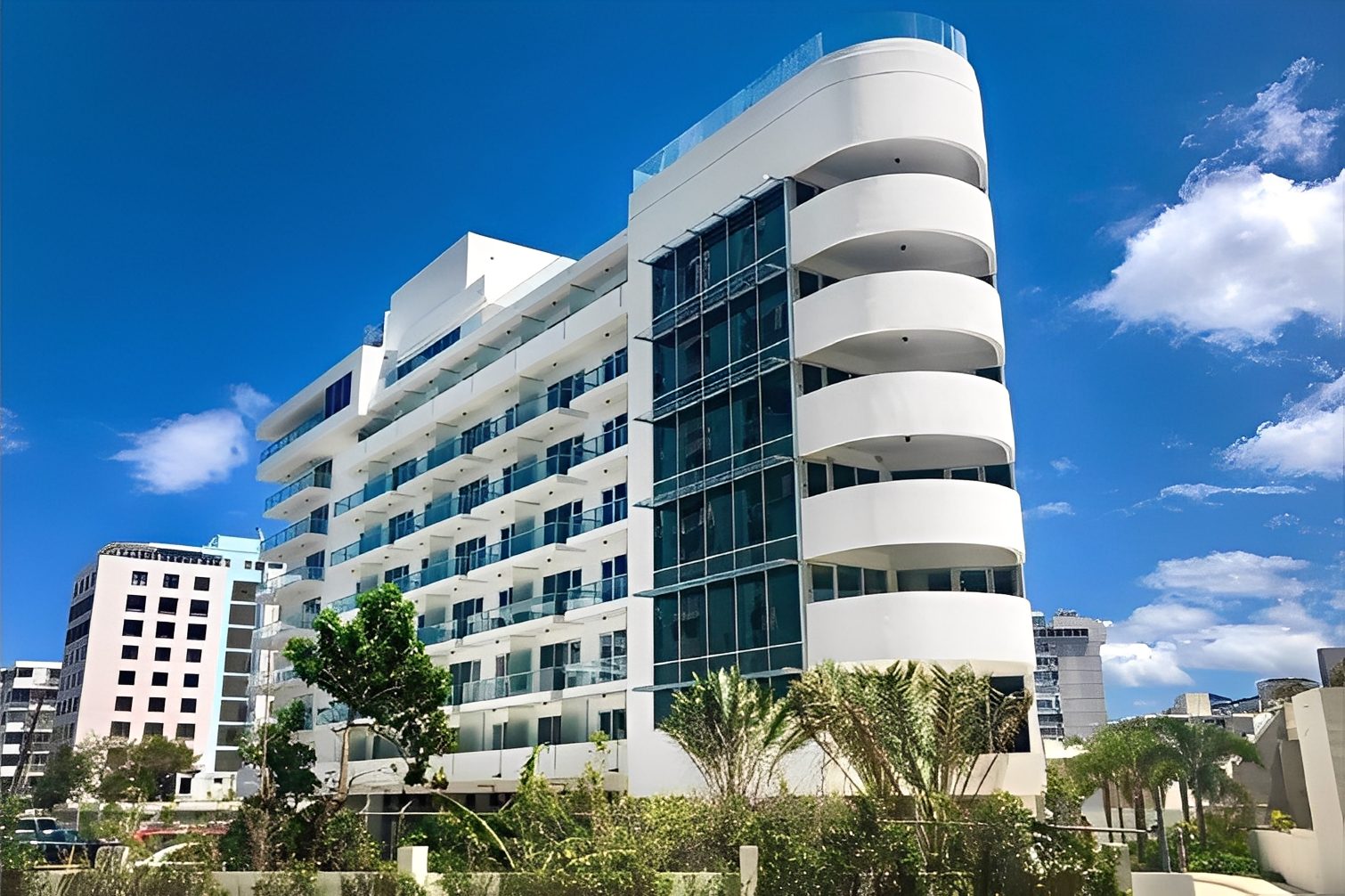 Modern white building under clear blue sky.